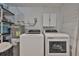 Functional laundry room with new washer and dryer and built-in storage at 540 Firefly Ln, Apollo Beach, FL 33572