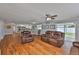 Spacious open-plan living area with wood floors connecting to the kitchen, offering a bright and airy feel at 540 Firefly Ln, Apollo Beach, FL 33572