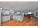 Open-concept living space with hardwood floors featuring a kitchen and living room area at 540 Firefly Ln, Apollo Beach, FL 33572
