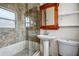 Updated bathroom featuring glass-enclosed shower, wooden vanity, and neutral decor at 5483 37Th N Ave, St Petersburg, FL 33710