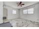 Bright bedroom featuring white walls, ceiling fan, and tile floors at 5483 37Th N Ave, St Petersburg, FL 33710