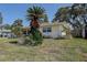 Side view of the one-story home with lawn, plants, and a fenced yard at 5483 37Th N Ave, St Petersburg, FL 33710