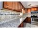 Updated kitchen featuring granite counters, tile backsplash, stainless appliances, and stylish cabinetry at 5483 37Th N Ave, St Petersburg, FL 33710
