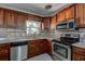 Updated kitchen featuring stainless appliances, granite counters, tile backsplash, and modern finishes at 5483 37Th N Ave, St Petersburg, FL 33710