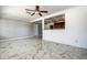 Open living room featuring modern flooring, neutral walls, and stylish ceiling fan at 5483 37Th N Ave, St Petersburg, FL 33710