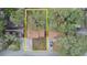 Aerial view of a home showcasing the roof, yard and mature tree coverage with a yellow boundary at 5533 Golden Nugget Dr, Holiday, FL 34690