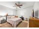 Bedroom features a ceiling fan, two windows, and side tables at 5533 Golden Nugget Dr, Holiday, FL 34690