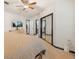 Spacious bedroom with carpet, fan, and a mirrored closet door at 5533 Golden Nugget Dr, Holiday, FL 34690