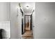 Hallway with wood-look floors, contrasted with white walls and black door trim at 5533 Golden Nugget Dr, Holiday, FL 34690