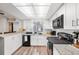 Well-lit kitchen featuring white cabinets, modern appliances, and granite countertops at 5533 Golden Nugget Dr, Holiday, FL 34690