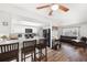 Bright open-concept kitchen featuring white cabinetry, a breakfast bar, and modern appliances at 5533 Golden Nugget Dr, Holiday, FL 34690