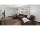 Comfortable living room showcasing hardwood floors and a large sectional sofa at 5533 Golden Nugget Dr, Holiday, FL 34690