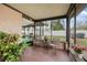 Relaxing screened porch with brick flooring and views of the backyard at 5533 Golden Nugget Dr, Holiday, FL 34690