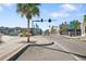 View of a tree-lined street featuring well-maintained sidewalks and commercial buildings in a sunny setting at 5533 Golden Nugget Dr, Holiday, FL 34690
