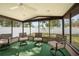 Enclosed sunroom with ceiling fan and views of the backyard at 5533 Golden Nugget Dr, Holiday, FL 34690