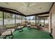 Enclosed sunroom with ceiling fan and views of the fenced-in backyard at 5533 Golden Nugget Dr, Holiday, FL 34690