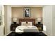 Stylish bedroom with a comfortable bed, decorative lamps, and modern furnishings at 5676 Red Kite Dr, Wimauma, FL 33598