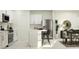 Modern kitchen featuring white cabinets, stainless steel appliances, and an island with bar seating at 5676 Red Kite Dr, Wimauma, FL 33598