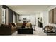 Open-concept living room with stylish decor, comfortable seating, and seamless flow to the kitchen at 5676 Red Kite Dr, Wimauma, FL 33598