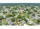 An aerial view showcases a home nestled in a verdant neighborhood with mature trees and manicured lawns at 6195 28Th N Ave, St Petersburg, FL 33710