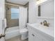 Bright bathroom with shower and tub, stylish vanity, and neutral tile at 6195 28Th N Ave, St Petersburg, FL 33710