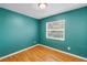 Brightly painted bedroom with hardwood floors and window at 6195 28Th N Ave, St Petersburg, FL 33710