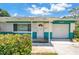View of the front entrance with a white door and an attached one car garage at 6195 28Th N Ave, St Petersburg, FL 33710