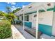 Cozy front porch featuring a turquoise exterior, a white door, and space for seating at 6195 28Th N Ave, St Petersburg, FL 33710