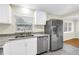 Modern kitchen featuring stainless steel appliances, a dual sink, and plenty of natural light at 6195 28Th N Ave, St Petersburg, FL 33710
