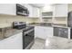 Updated kitchen featuring stainless steel appliances, granite countertops, and white cabinetry at 6195 28Th N Ave, St Petersburg, FL 33710
