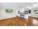 An open-concept living room with hardwood floors and a view of the kitchen at 6195 28Th N Ave, St Petersburg, FL 33710