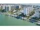 An aerial view featuring luxury waterfront condos, a pool, a tennis court, and a marina at 660 Island Way #206 # 206, Clearwater, FL 33767