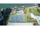 An aerial view featuring a tennis court, swimming pool, marina, and luxury waterfront condos at 660 Island Way #206 # 206, Clearwater, FL 33767