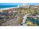 Aerial view showcasing a beach parking lot, hotels, palm trees, and the ocean in the background at 660 Island Way #206 # 206, Clearwater, FL 33767