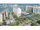 An aerial view of luxury waterfront condos, a pool, tennis court, and marina in a coastal setting at 660 Island Way #206 # 206, Clearwater, FL 33767