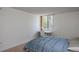 Simple bedroom featuring a window, desk, and queen-sized bed at 660 Island Way #206 # 206, Clearwater, FL 33767