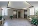 Well-lit elevator lobby with tile flooring, striped accent wall, seating, plants, and stainless steel elevators at 660 Island Way #206 # 206, Clearwater, FL 33767