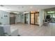 Bright elevator lobby featuring tile flooring, multiple elevators, and seating near a window at 660 Island Way #206 # 206, Clearwater, FL 33767
