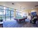 Game room featuring a pool table, seating, a TV, and large windows providing natural light and a view at 660 Island Way #206 # 206, Clearwater, FL 33767