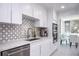 Modern kitchen featuring stainless steel appliances and a tiled backsplash at 660 Island Way #206 # 206, Clearwater, FL 33767