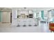 An open concept living space boasts a breakfast bar, dining area, and light, airy design at 660 Island Way #206 # 206, Clearwater, FL 33767