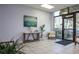 Well-lit lobby with modern decor, a table with a lamp, artwork, seating, and a view of the outside at 660 Island Way #206 # 206, Clearwater, FL 33767