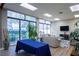 Bright lounge with a blue tablecloth, comfortable seating area, a TV, and large windows offering outdoor views at 660 Island Way #206 # 206, Clearwater, FL 33767