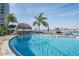 Community pool area with a tiki hut overlooking the bay at 660 Island Way #206 # 206, Clearwater, FL 33767