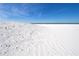 Beautiful white sand beach with blue sky, creating a serene coastal landscape with gentle waves in the distance at 660 Island Way #206 # 206, Clearwater, FL 33767