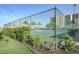 Tennis court with lush landscaping and a luxury condo building in the background at 660 Island Way #206 # 206, Clearwater, FL 33767
