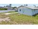 The home's backyard provides ample space for outdoor activities, featuring an expansive, mostly barren lawn at 7322 Ellis Ln, Port Charlotte, FL 33981