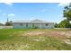 The home's backyard provides ample space for outdoor activities, featuring an expansive, mostly barren lawn at 7322 Ellis Ln, Port Charlotte, FL 33981