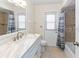 Bright bathroom features a marble countertop, bathtub and shower, and outdoor access at 7322 Ellis Ln, Port Charlotte, FL 33981