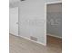 Empty bedroom with wood flooring, door, and closet space at 7322 Ellis Ln, Port Charlotte, FL 33981
